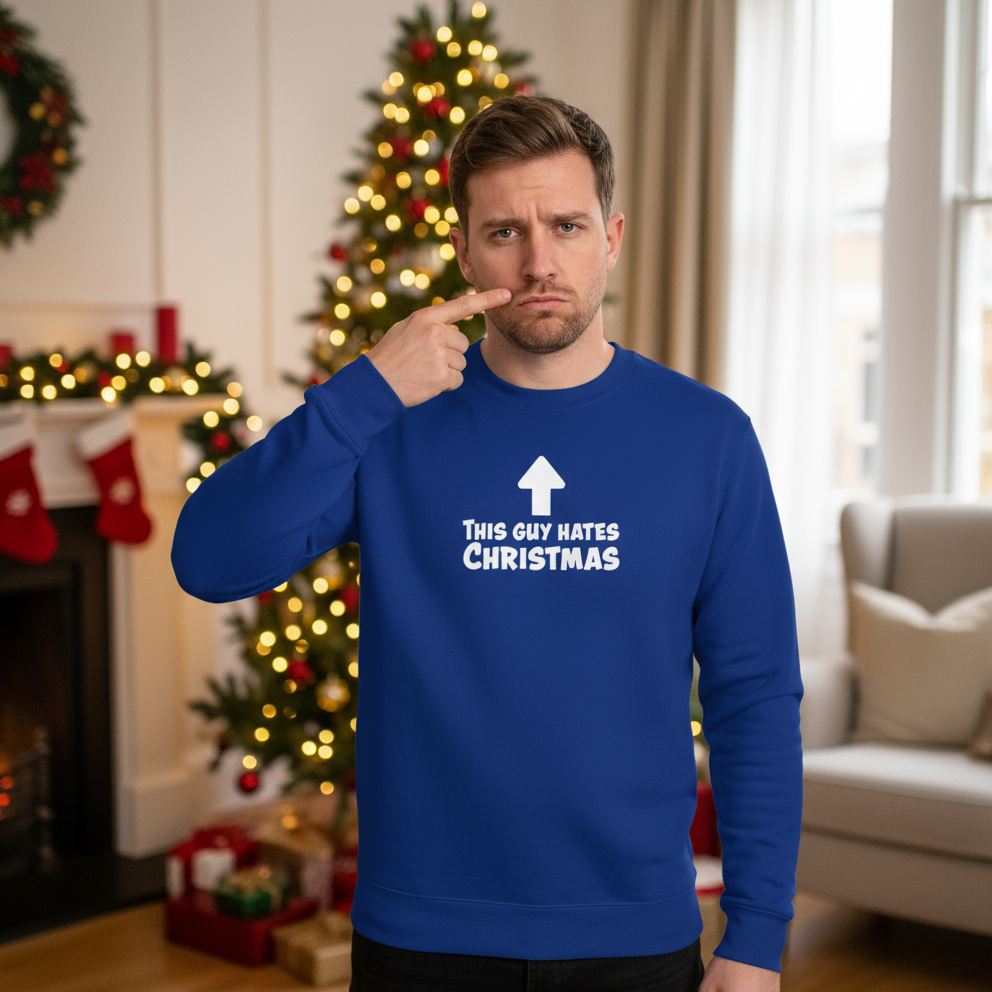 Man wearing a blue sweater with text in a festive room with Christmas decorations.