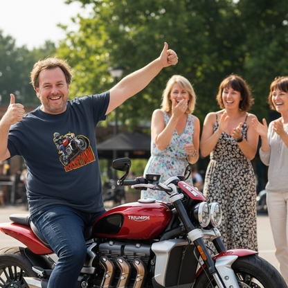 Man sitting on a red Triumph motorcycle with people clapping and giving thumbs up in the background.