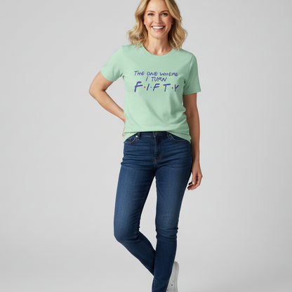 Woman wearing a light green t-shirt with text and blue jeans on a gray background