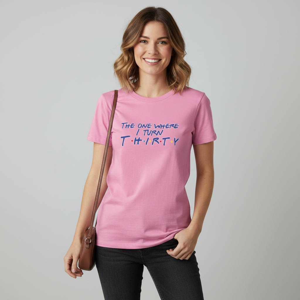 Woman wearing a pink t-shirt with text, standing against a plain background