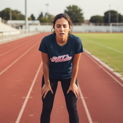 woman stood on a running track wearing a navy slogan t-shirt with the text 'used to be athletic'