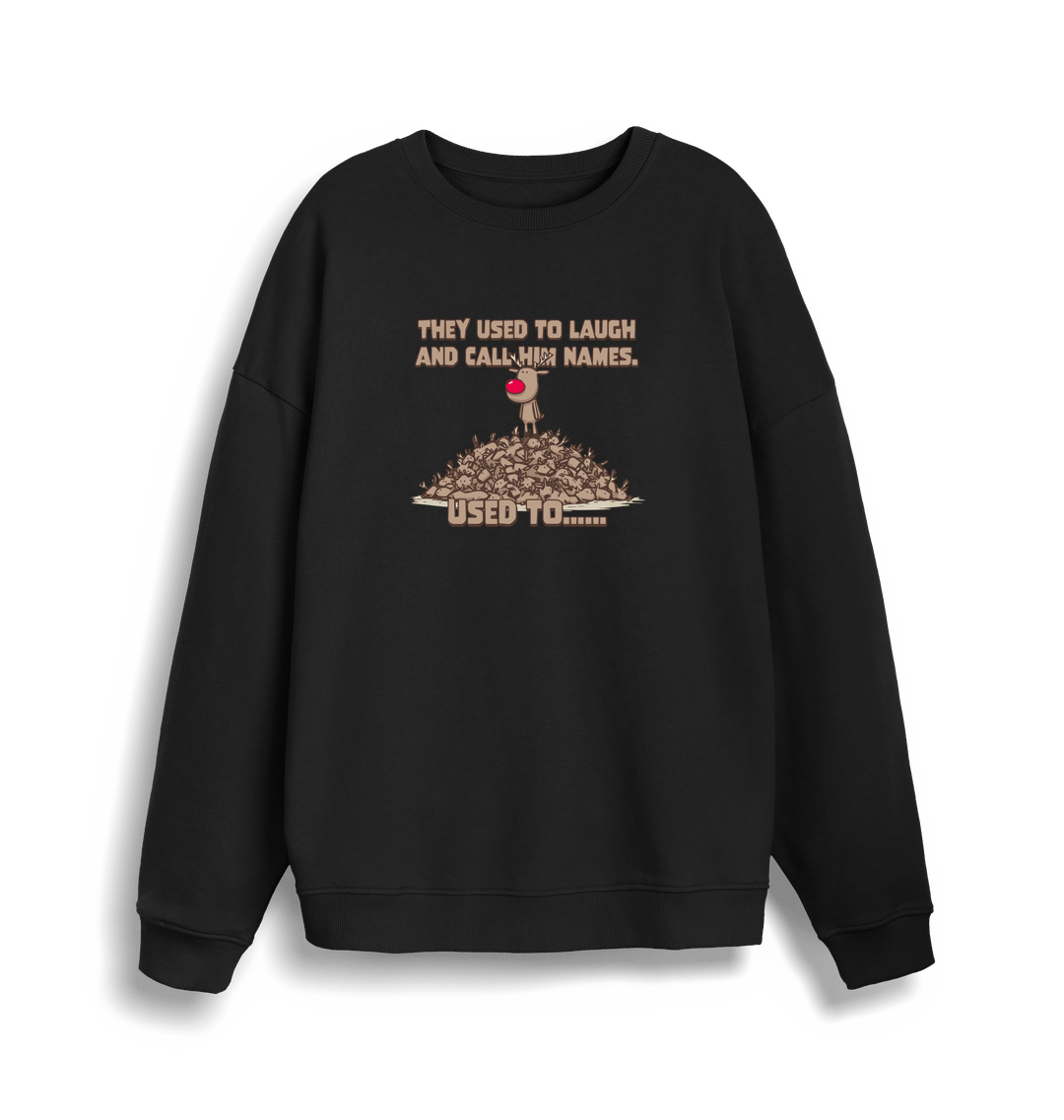 black christmas sweater with the graphic of rudolph stood on top of a pile of reindeer and the slogan 'they used to laugh and call him names used to... '