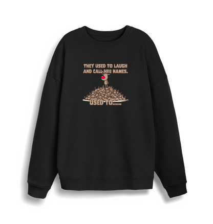 black christmas sweater with the graphic of rudolph stood on top of a pile of reindeer and the slogan 'they used to laugh and call him names used to... '