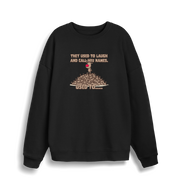 black christmas sweater with the graphic of rudolph stood on top of a pile of reindeer and the slogan 'they used to laugh and call him names used to... '