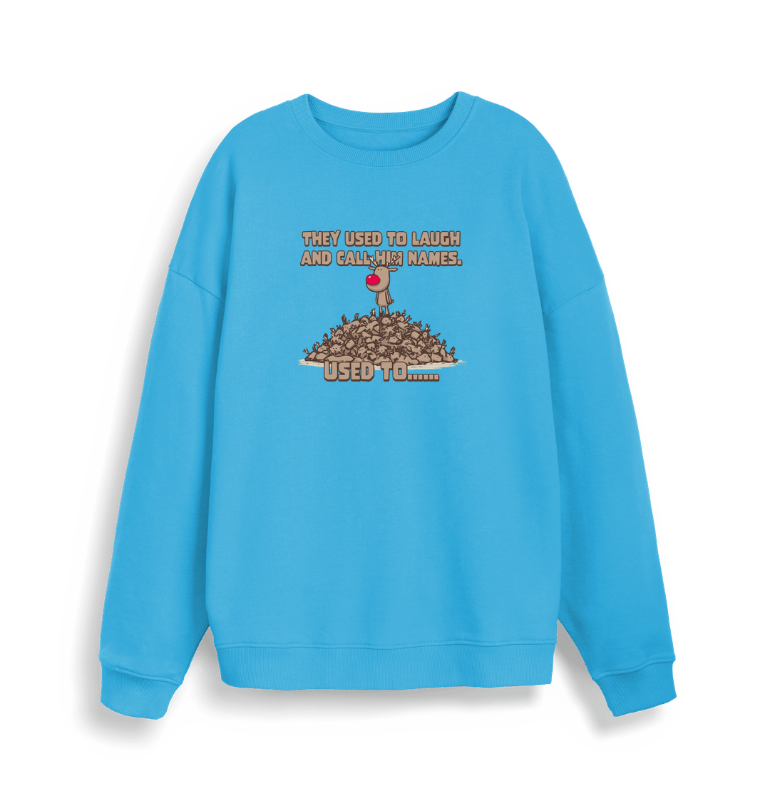 blue christmas sweater with the graphic of rudolph stood on top of a pile of reindeer and the slogan 'they used to laugh and call him names used to... '