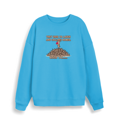 blue christmas sweater with the graphic of rudolph stood on top of a pile of reindeer and the slogan 'they used to laugh and call him names used to... '