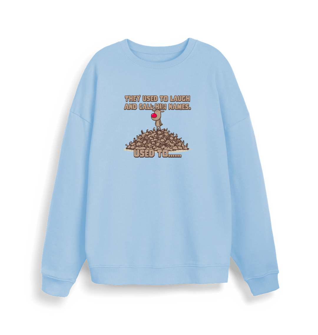 light blue christmas sweater with the graphic of rudolph stood on top of a pile of reindeer and the slogan 'they used to laugh and call him names used to... '