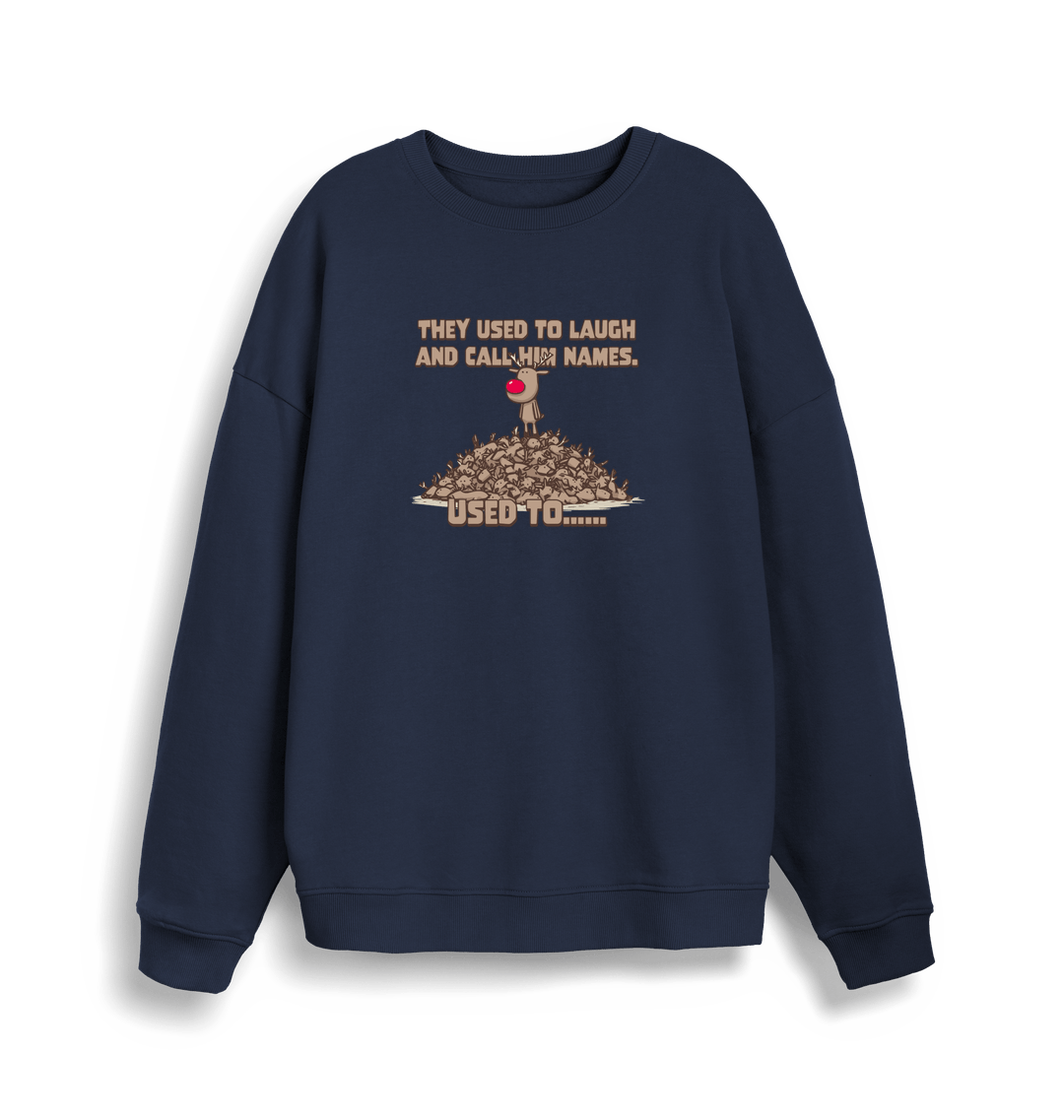 navy christmas sweater with the graphic of rudolph stood on top of a pile of reindeer and the slogan 'they used to laugh and call him names used to... '