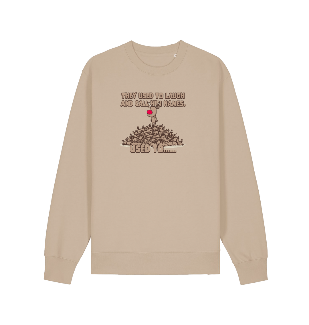 sand christmas sweater with the graphic of rudolph stood on top of a pile of reindeer and the slogan 'they used to laugh and call him names used to... '