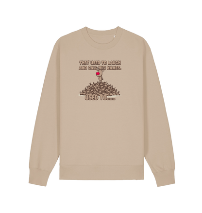 sand christmas sweater with the graphic of rudolph stood on top of a pile of reindeer and the slogan 'they used to laugh and call him names used to... '