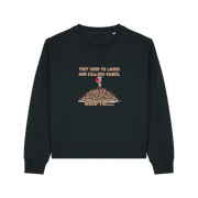 black christmas sweater with the graphic of rudoph stood ontop of a pile of reindeer and the slogan 'they used to laugh and call him names used to ..'