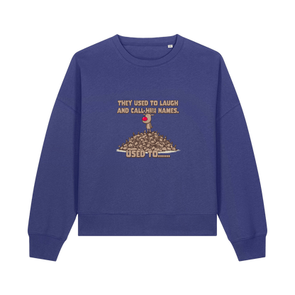 blue christmas sweater with the graphic of rudoph stood ontop of a pile of reindeer and the slogan 'they used to laugh and call him names used to ..'