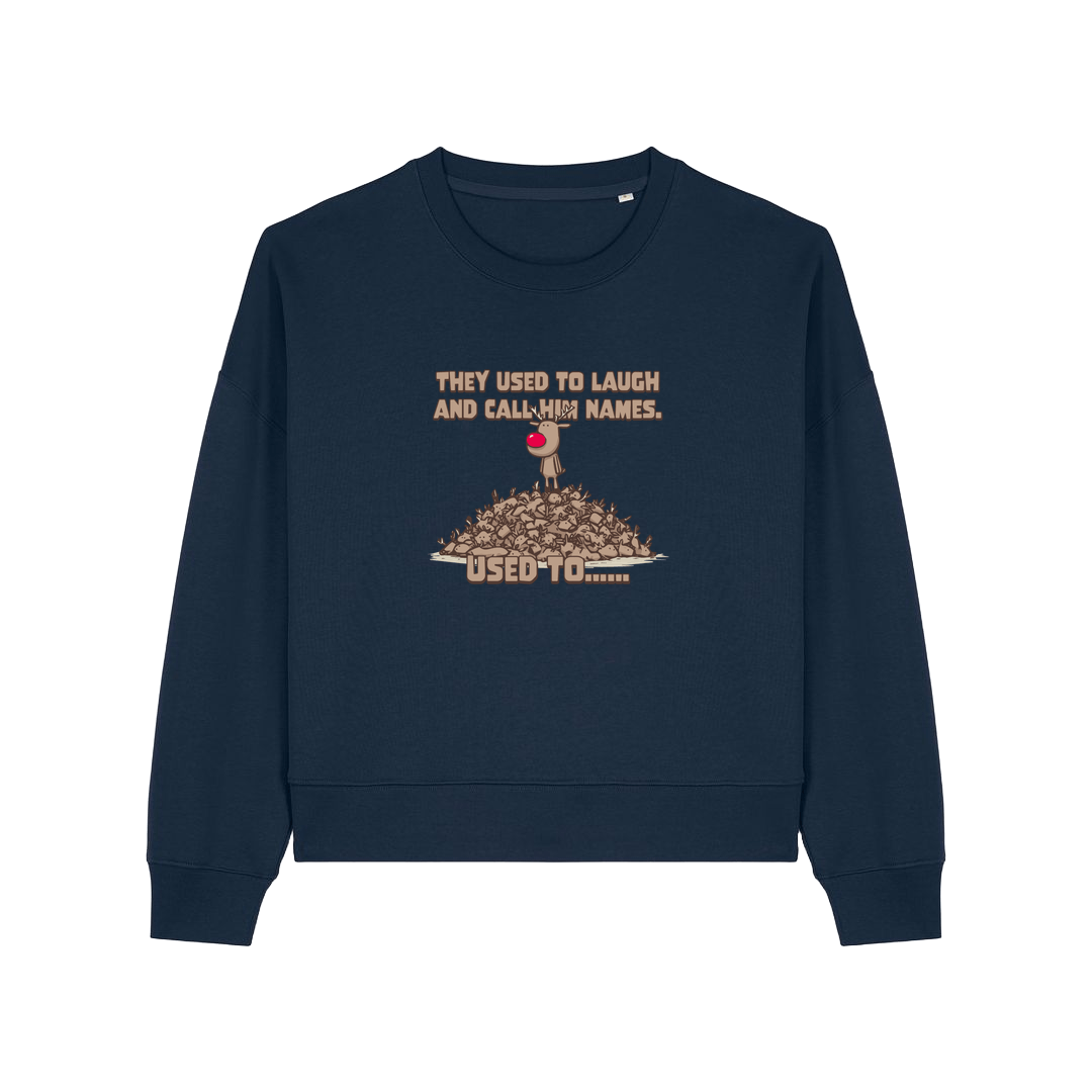 navy christmas sweater with the graphic of rudoph stood ontop of a pile of reindeer and the slogan 'they used to laugh and call him names used to ..'