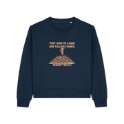 navy christmas sweater with the graphic of rudoph stood ontop of a pile of reindeer and the slogan 'they used to laugh and call him names used to ..'