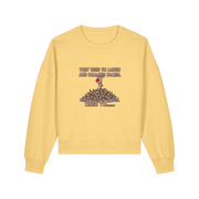 yellow christmas sweater with the graphic of rudoph stood ontop of a pile of reindeer and the slogan 'they used to laugh and call him names used to ..'