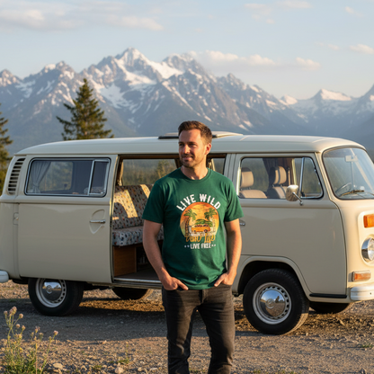 Man standing in front of a vintage van with mountains in the background