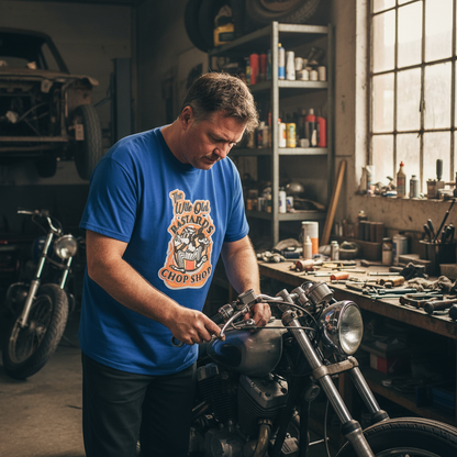 Man working on a motorcycle in a workshop with tools and equipment around