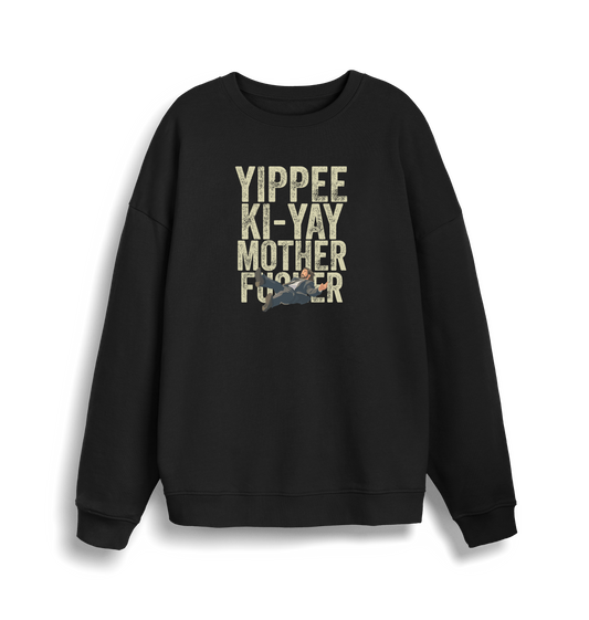 black christmas jumper with the graphic of a man falling and the slogan 'yippee ki-yay mother fucker'