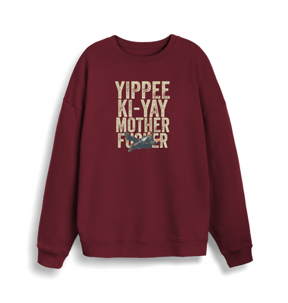 burgundy christmas jumper with the graphic of a man falling and the slogan 'yippee ki-yay mother fucker'