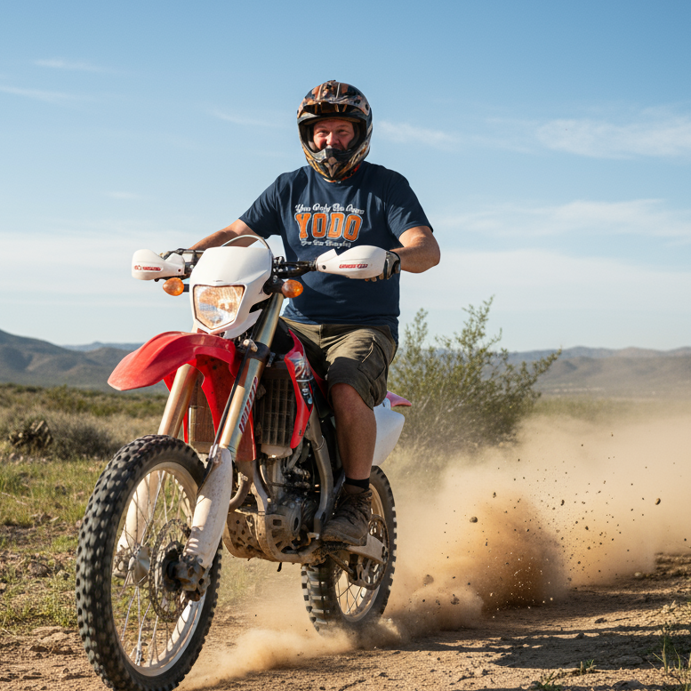 Person riding a dirt bike in an open landscape with mountains in the background